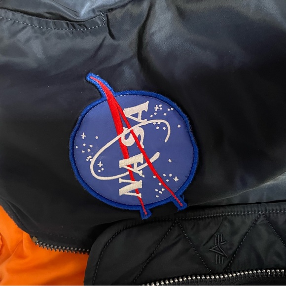 Navy blue bomber jacket With orange inside 
Goes for $300
Flips inside out - Picture 4 of 7